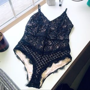 Black and nude lace body suit